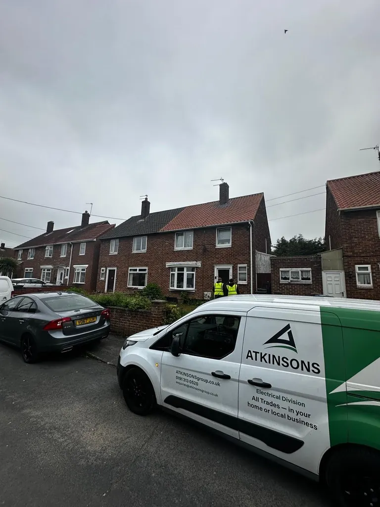 ATKINSONS Electrical Division van and engineers on a residential street