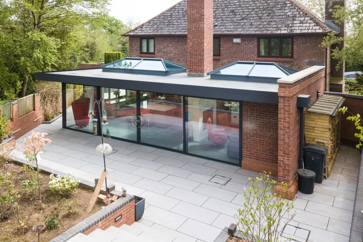 Flat-roof rear extension with two roof lanterns and full-width sliding glass built by ATKINSONS