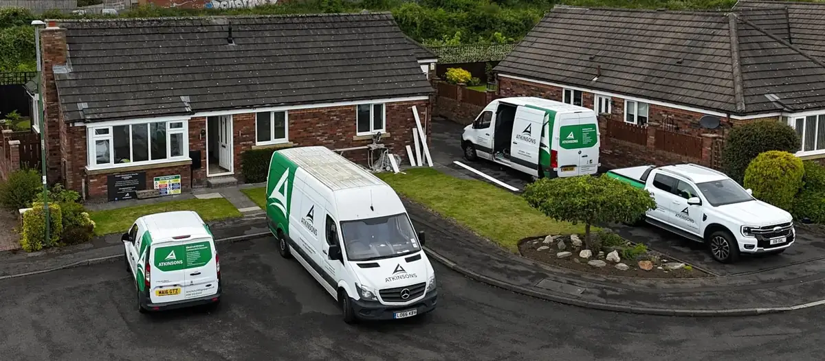 Four ATKINSONS vans and a pick-up parked outside one job in the North East